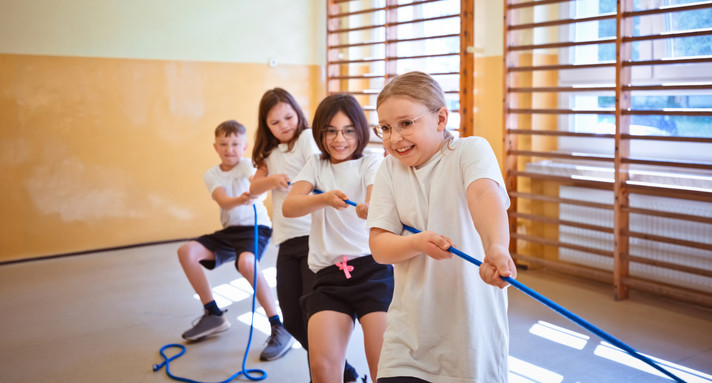 A group of school kids in a tug-of-war game