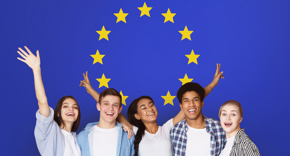 Student Exchange Programs In Eu. Multiracial Teens Posing Over Europe Union Flag