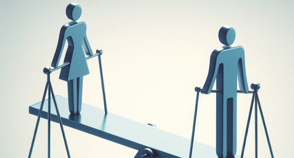 Auf eienr Wippe stehen zwei Figuren stellvertretend für Männer und Frauen. 