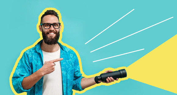 Young bearded hipster man holding a flashlight. Your text here. Discounts, sales, seasonal sales. Colorful summer concept. Modern creative artwork.