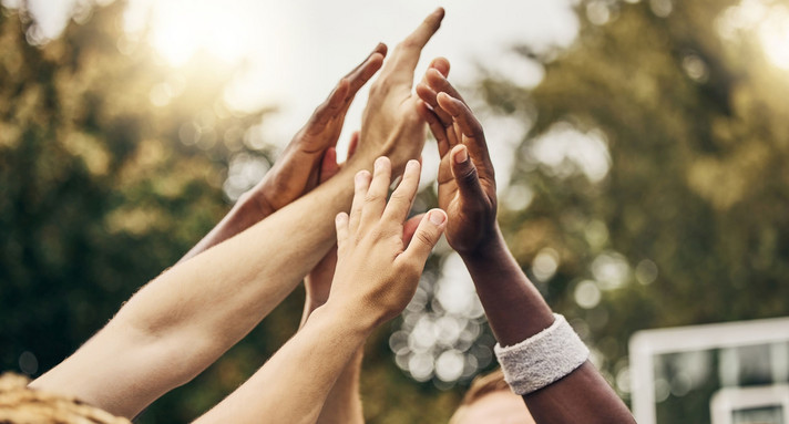 Basketball, winner and hands, team high five for outdoor game. Success, diversity and victory goal for sports for men. Teamwork, diversity and support, friends on basketball court together with coach