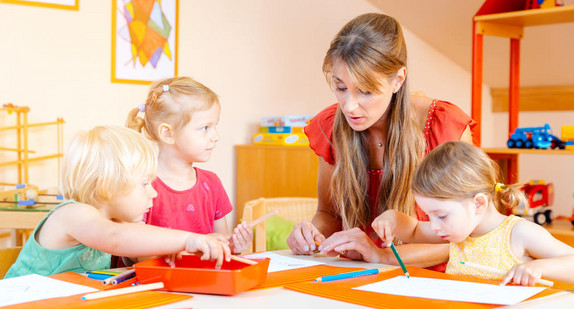 Children drawing in playgroup of nursery school