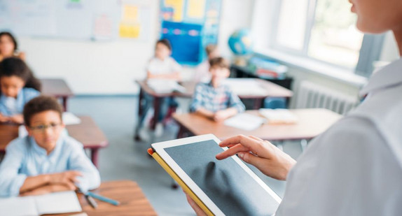 teacher using digital tablet